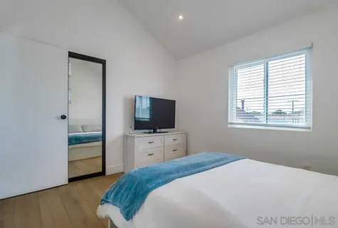 a bed room with a bed and a chair