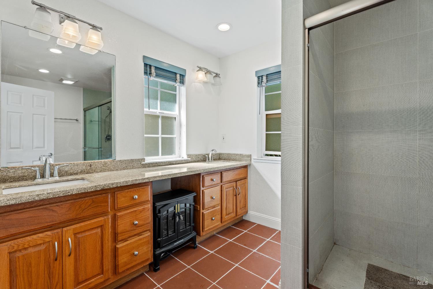 1701 Hickory Court Ukiah, CA 95482 - Photo 13 of 31 a spacious bathroom with a granite countertop sink a mirror and a shower