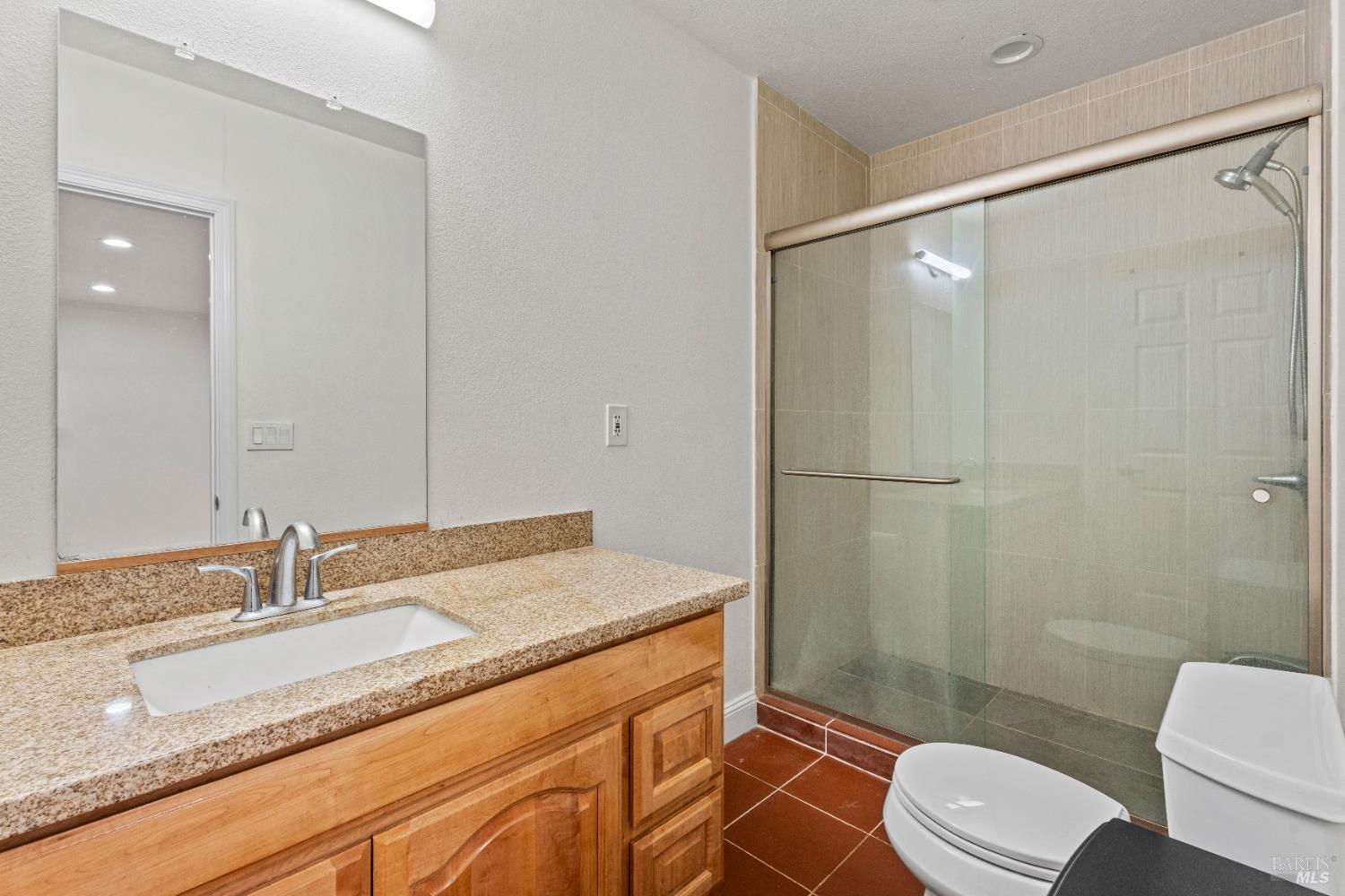 1701 Hickory Court Ukiah, CA 95482 - Photo 6 of 31 a bathroom with a granite countertop sink toilet and shower