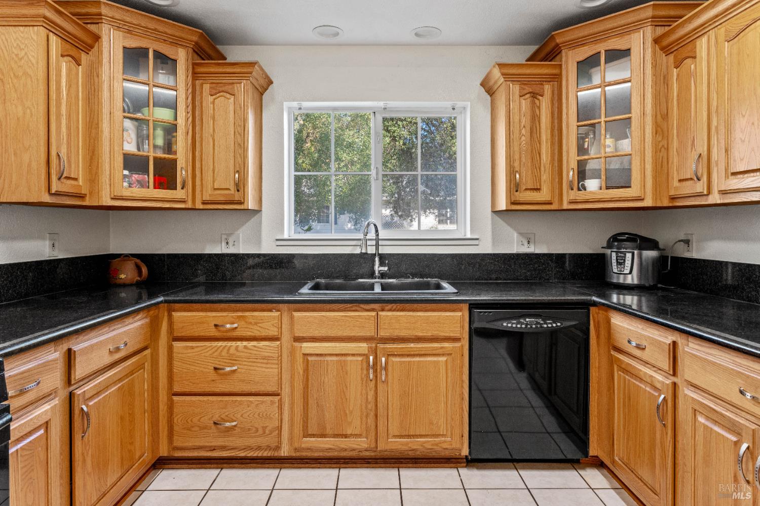 1701 Hickory Court Ukiah, CA 95482 - Photo 9 of 31 a kitchen with granite countertop white cabinets and sink