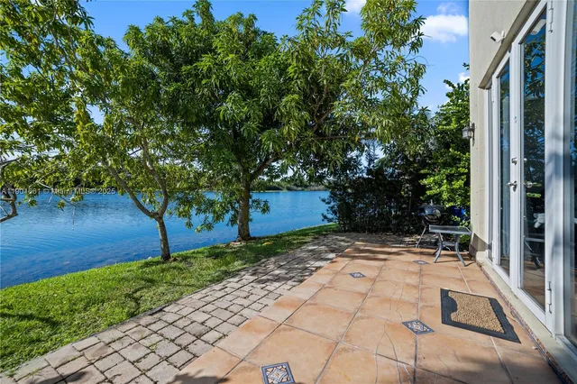 a picture of a glass door with a lake