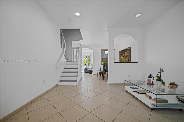 a living room with furniture and stairs
