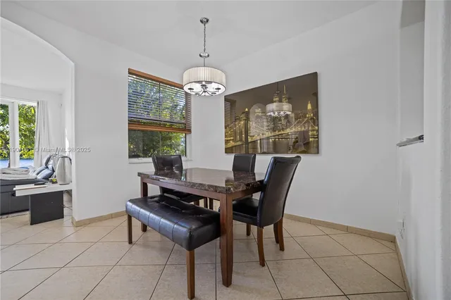 a dining room with furniture a window and a chandelier