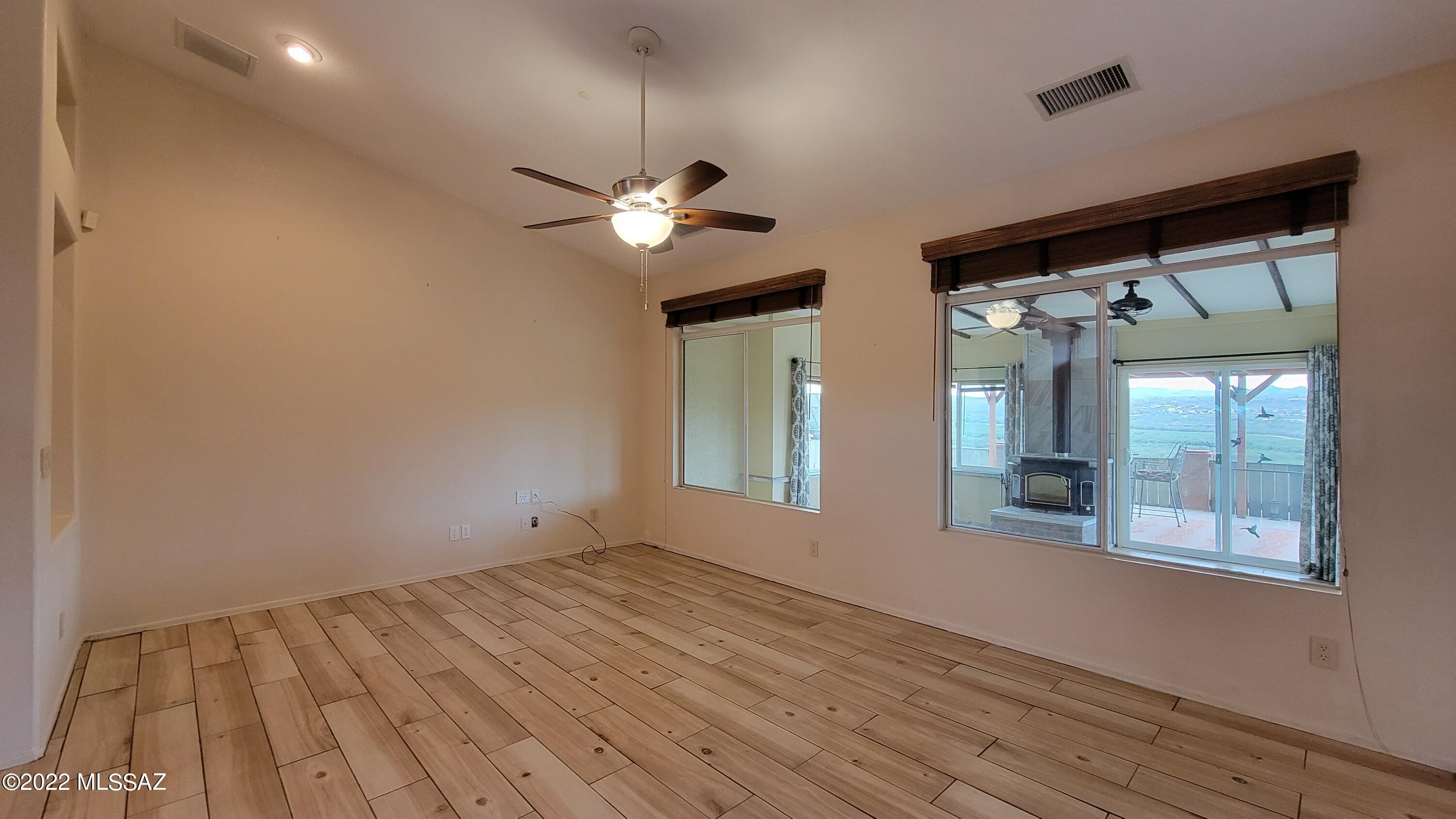 293 Valley View Drive Rio Rico, AZ 85648 - Photo 7 of 38 wooden floor in an empty room with a window