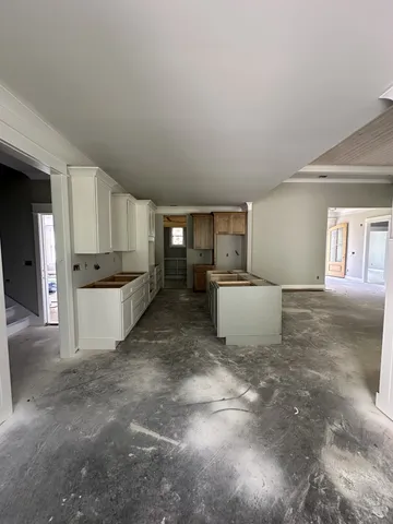 a view of a kitchen with furniture and wooden floor