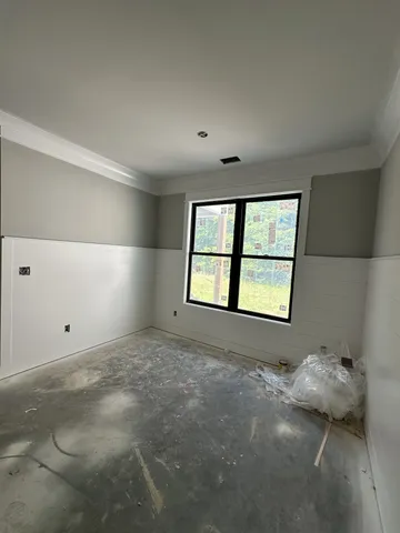 a view of a kitchen with furniture and a refrigerator