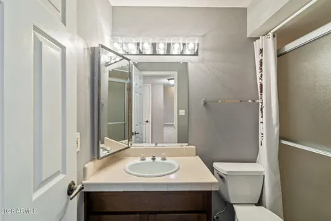 a bathroom with a glass shower door