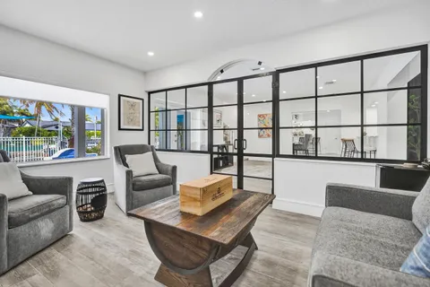 a living room with furniture and a floor to ceiling window