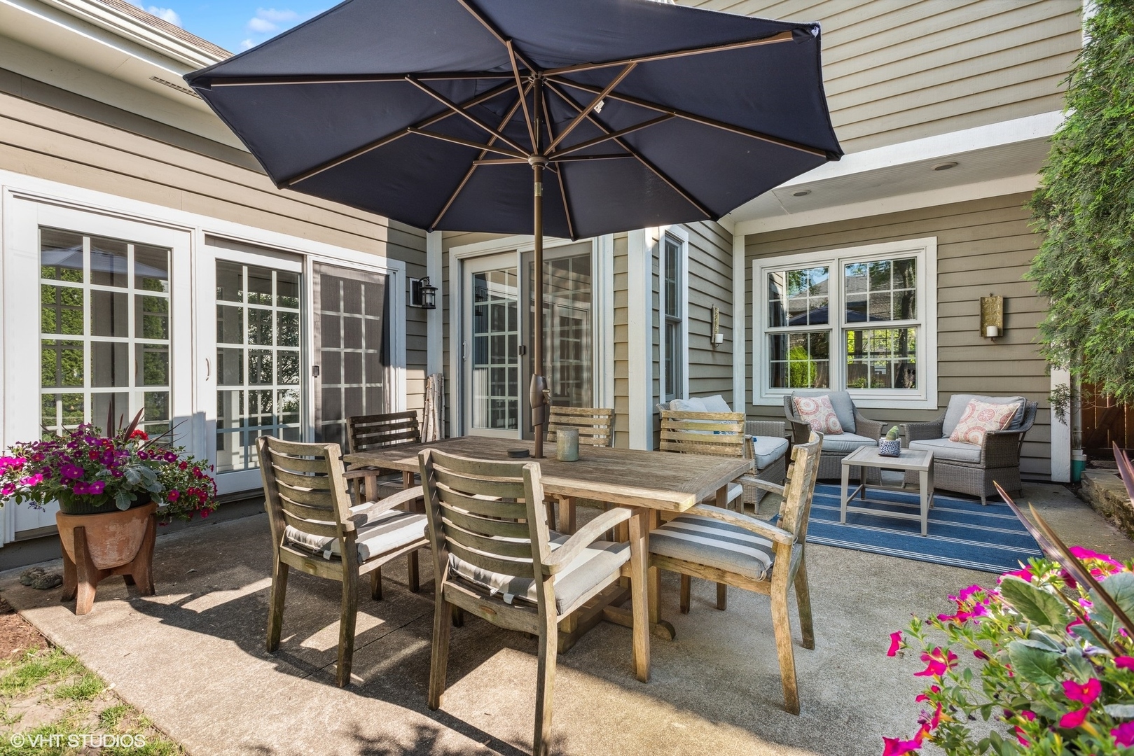 2320 Illinois Road Northbrook, IL 60062 - Photo 29 of 36 a patio with a table and chairs under an umbrella