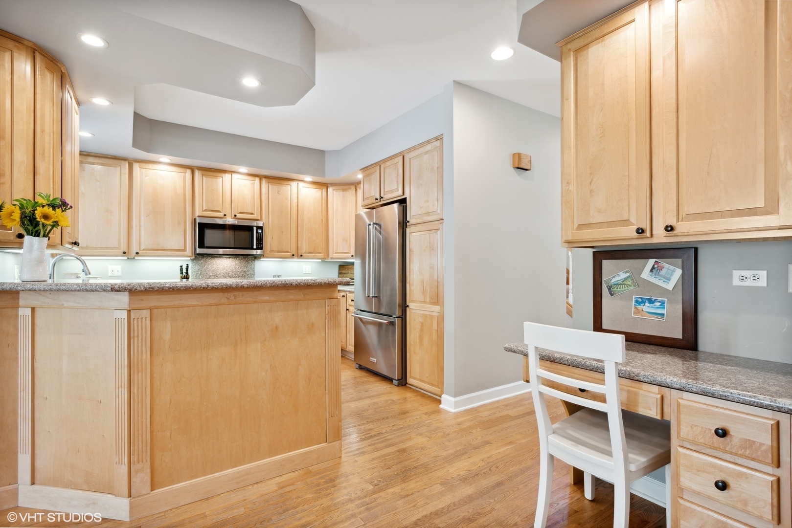 2320 Illinois Road Northbrook, IL 60062 - Photo 10 of 36 a kitchen with kitchen island granite countertop wooden cabinets and refrigerator