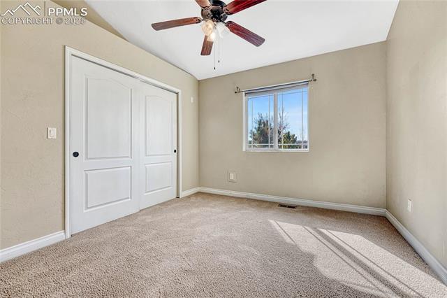 1502 York Road, Unit 102 Colorado Springs, CO 80920 - Photo 14 of 29 Unfurnished bedroom featuring visible vents, baseboards, and carpet flooring