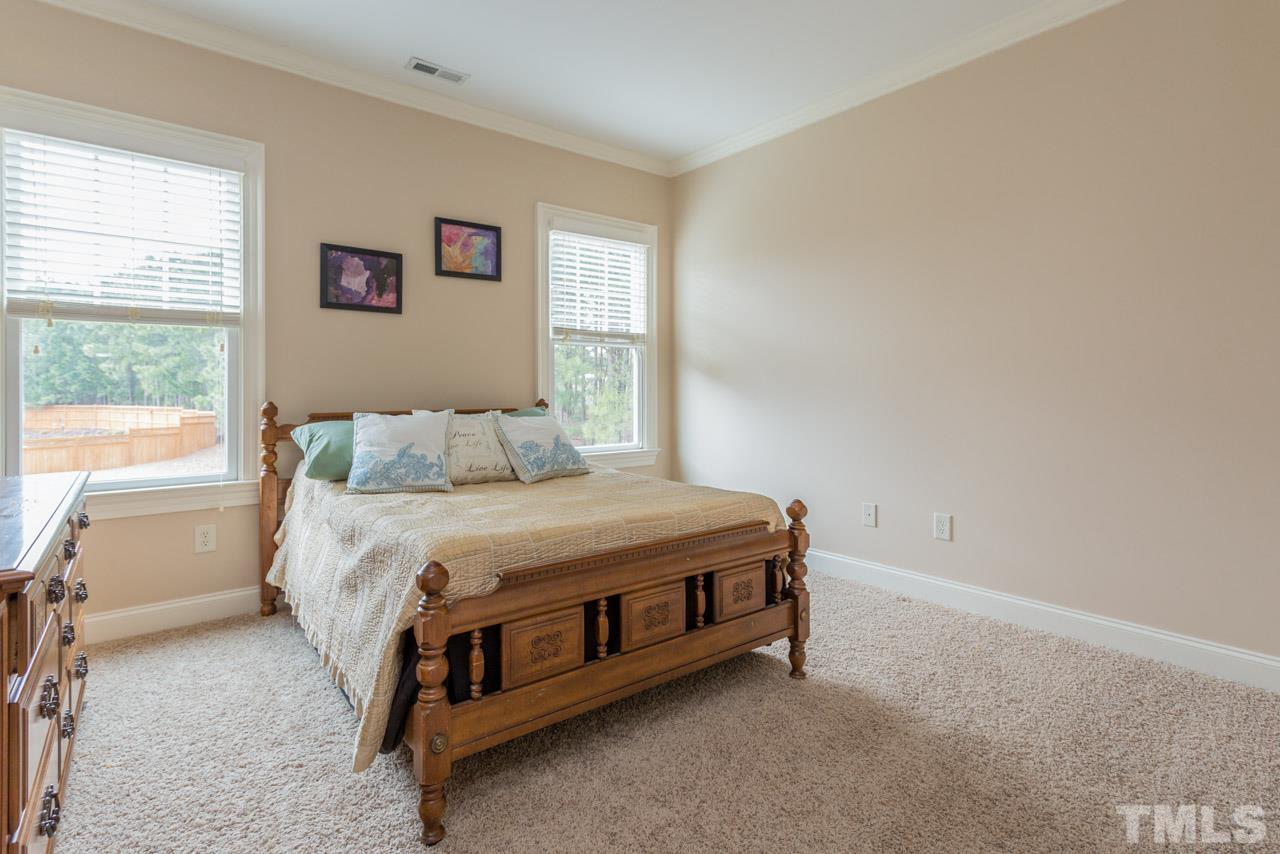 2313 Finley Ridge Lane Raleigh, NC 27615 - Photo 22 of 25 a bed sitting in a bedroom next to a window