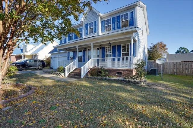 a view of a house with wooden floor and a fence