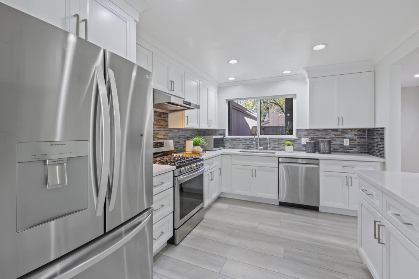 22856 Poplar Grove Square Cupertino, CA 95014 - Photo 9 of 82 a kitchen with white cabinets stainless steel appliances and a refrigerator