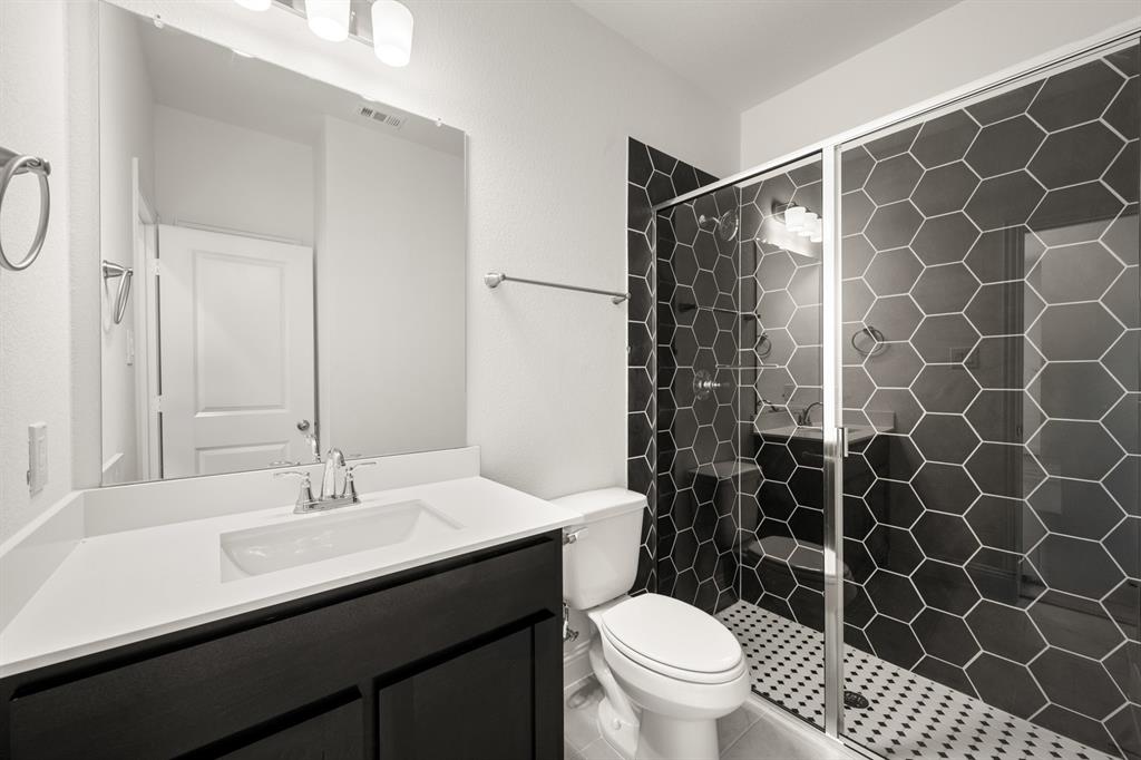 4357 Noble Lane Midlothian, TX 76065 - Photo 17 of 31 a bathroom with a sink a toilet a shower and a mirror