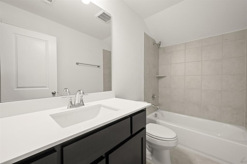 4357 Noble Lane Midlothian, TX 76065 - Photo 19 of 31 a bathroom with a sink a toilet a mirror and shower