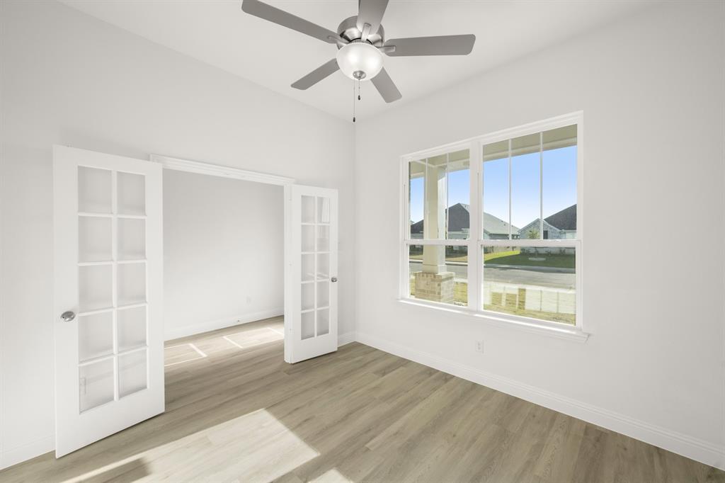 4357 Noble Lane Midlothian, TX 76065 - Photo 3 of 31 a view of an empty room with a window and wooden floor