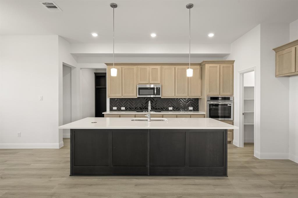 4357 Noble Lane Midlothian, TX 76065 - Photo 8 of 31 a large kitchen with kitchen island a sink stainless steel appliances and cabinets