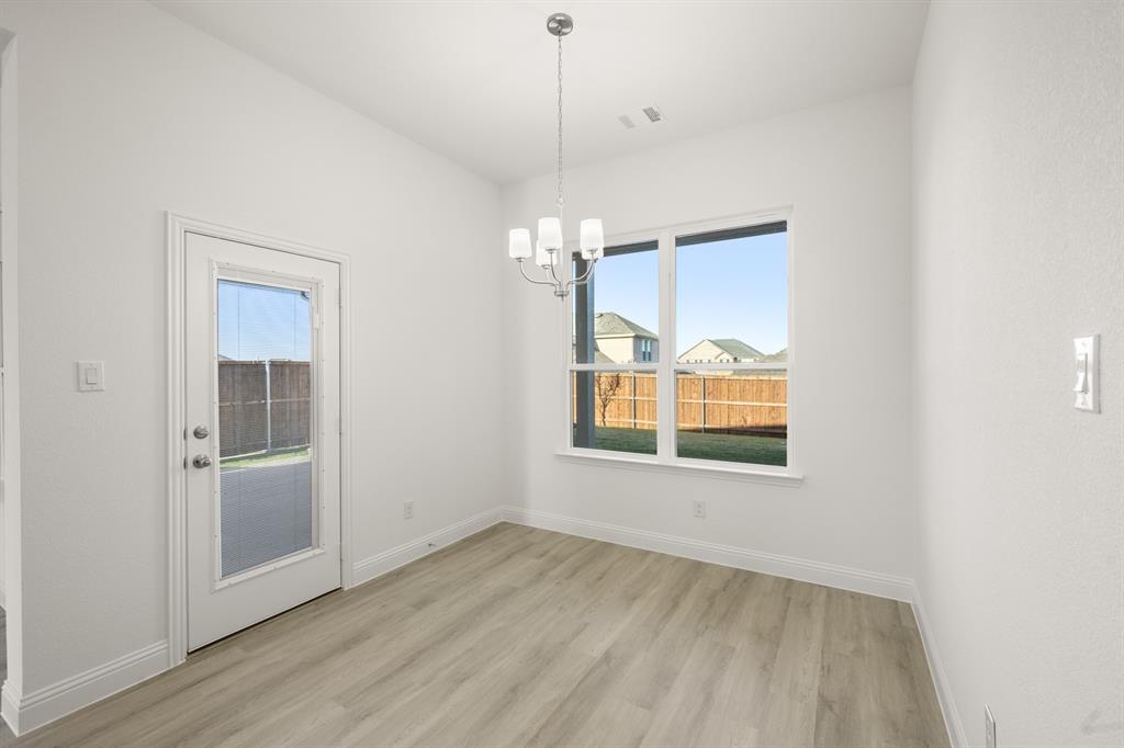 4357 Noble Lane Midlothian, TX 76065 - Photo 10 of 31 an empty room with wooden floor and windows