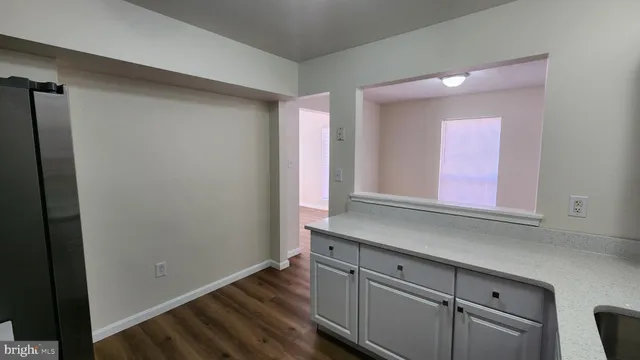 a kitchen with cabinets and a window