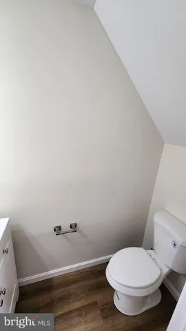 a white toilet sitting next to a shower