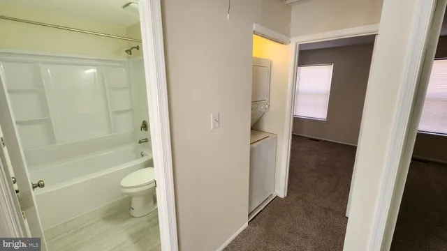 a bathroom with a granite countertop toilet a sink and shower