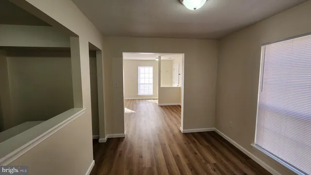a view of hallway with wooden floor
