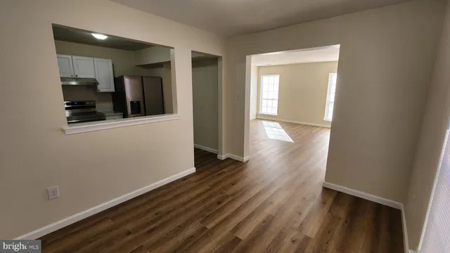 a view of hallway with wooden floor