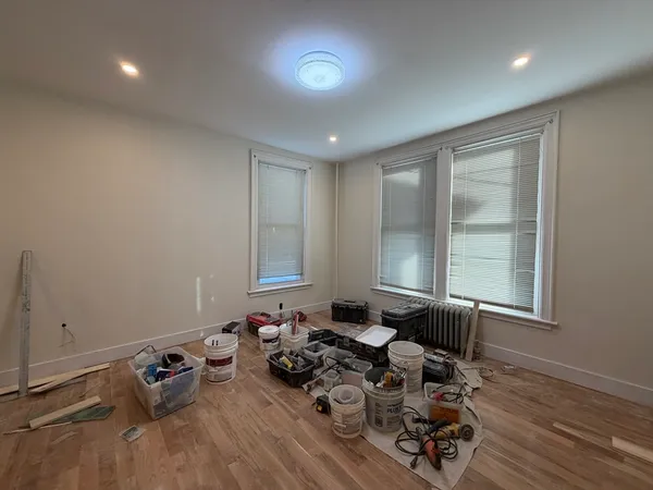 a room with furniture and two window