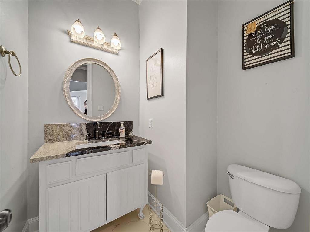 4332 Millsop Drive Carrollton, TX 75010 - Photo 11 of 37 a bathroom with a toilet a sink and a mirror