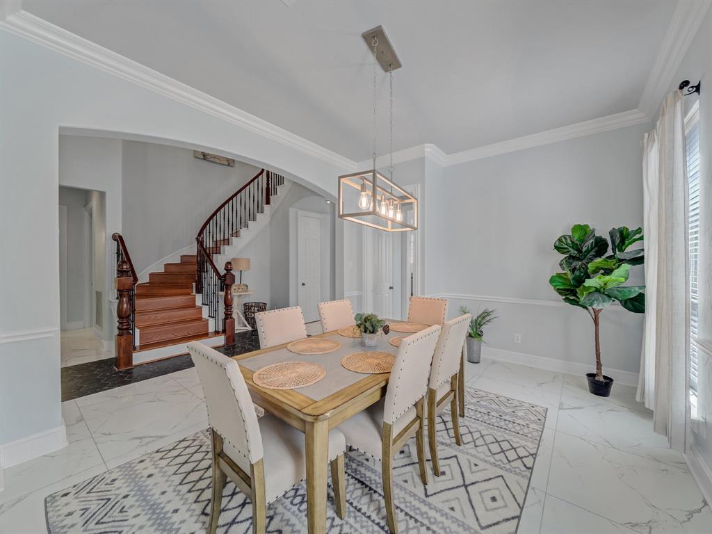 4332 Millsop Drive Carrollton, TX 75010 - Photo 15 of 37 a dining room with furniture and a potted plant