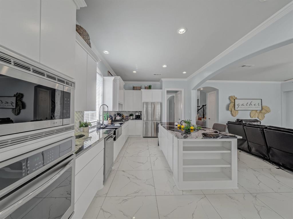 4332 Millsop Drive Carrollton, TX 75010 - Photo 18 of 37 a large white kitchen with stainless steel appliances lots of counter space and furniture