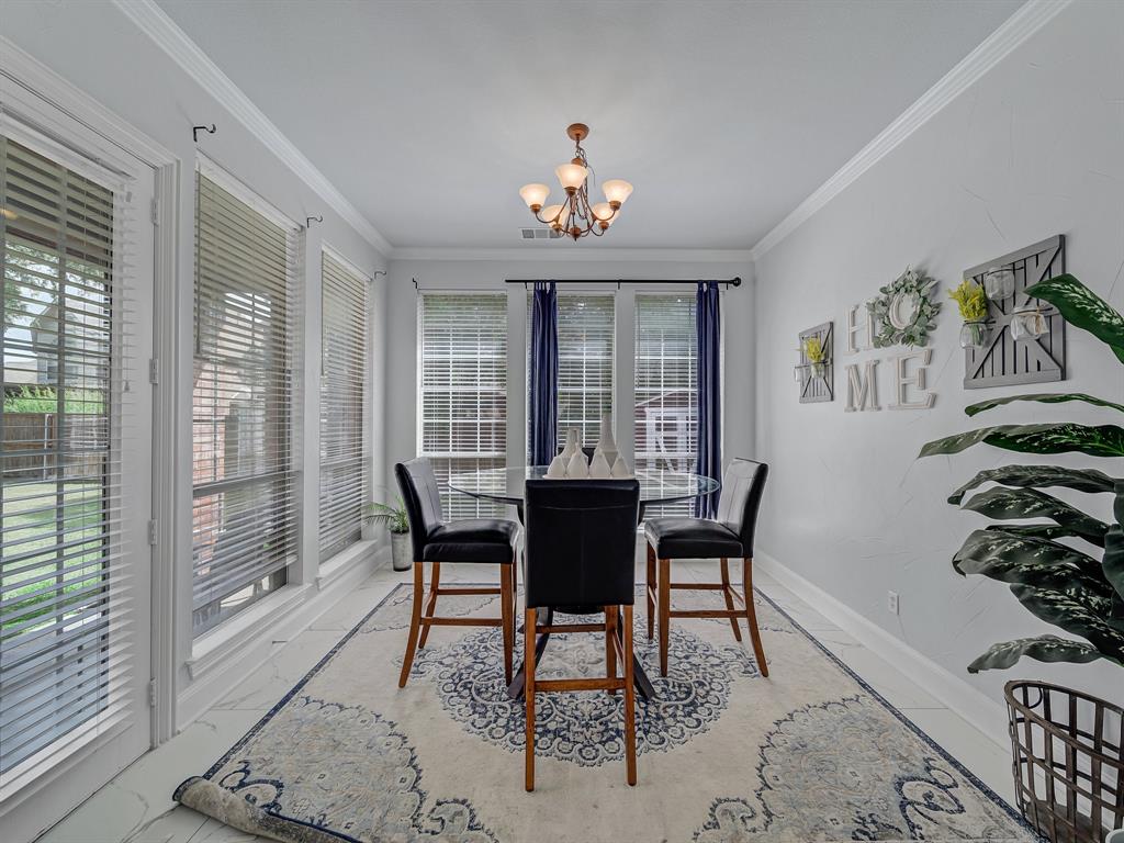 4332 Millsop Drive Carrollton, TX 75010 - Photo 20 of 37 a view of a dining room with furniture a chandelier and wooden floor