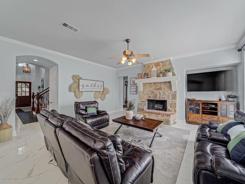 4332 Millsop Drive Carrollton, TX 75010 - Photo 21 of 37 a living room with furniture a flat screen tv and a fireplace