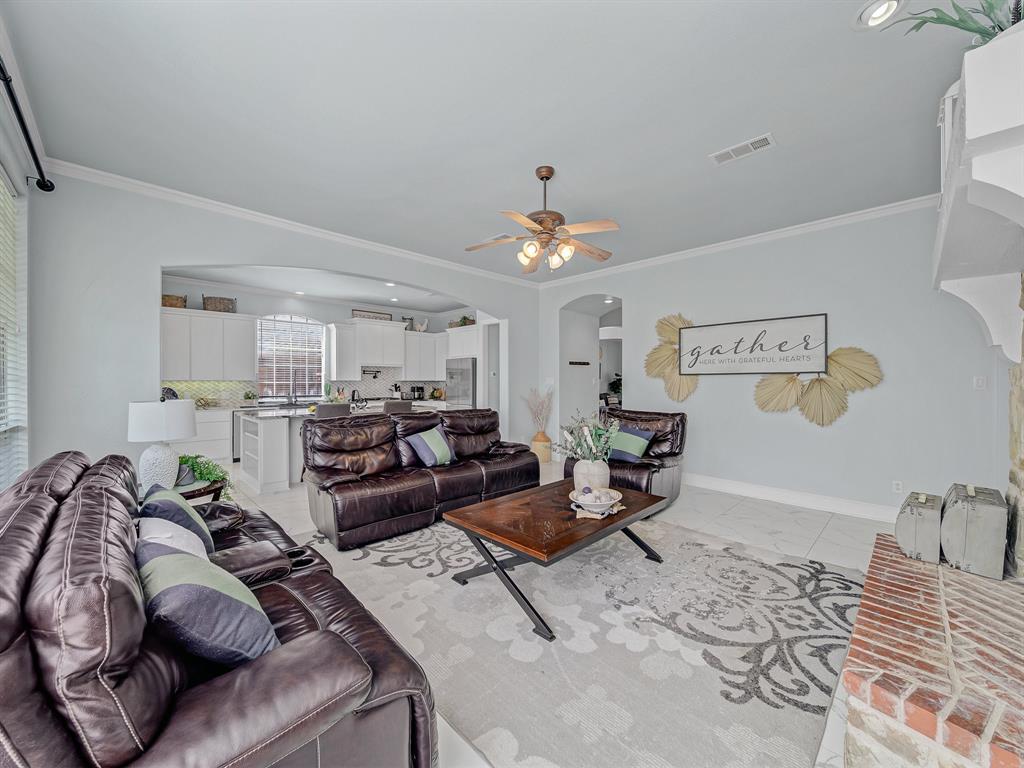 4332 Millsop Drive Carrollton, TX 75010 - Photo 23 of 37 a living room with furniture and a chandelier