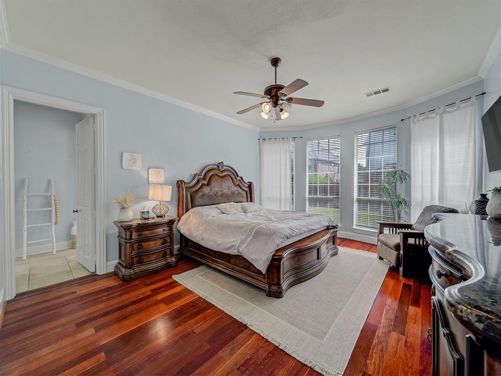4332 Millsop Drive Carrollton, TX 75010 - Photo 27 of 37 a bedroom with a bed and wooden floor