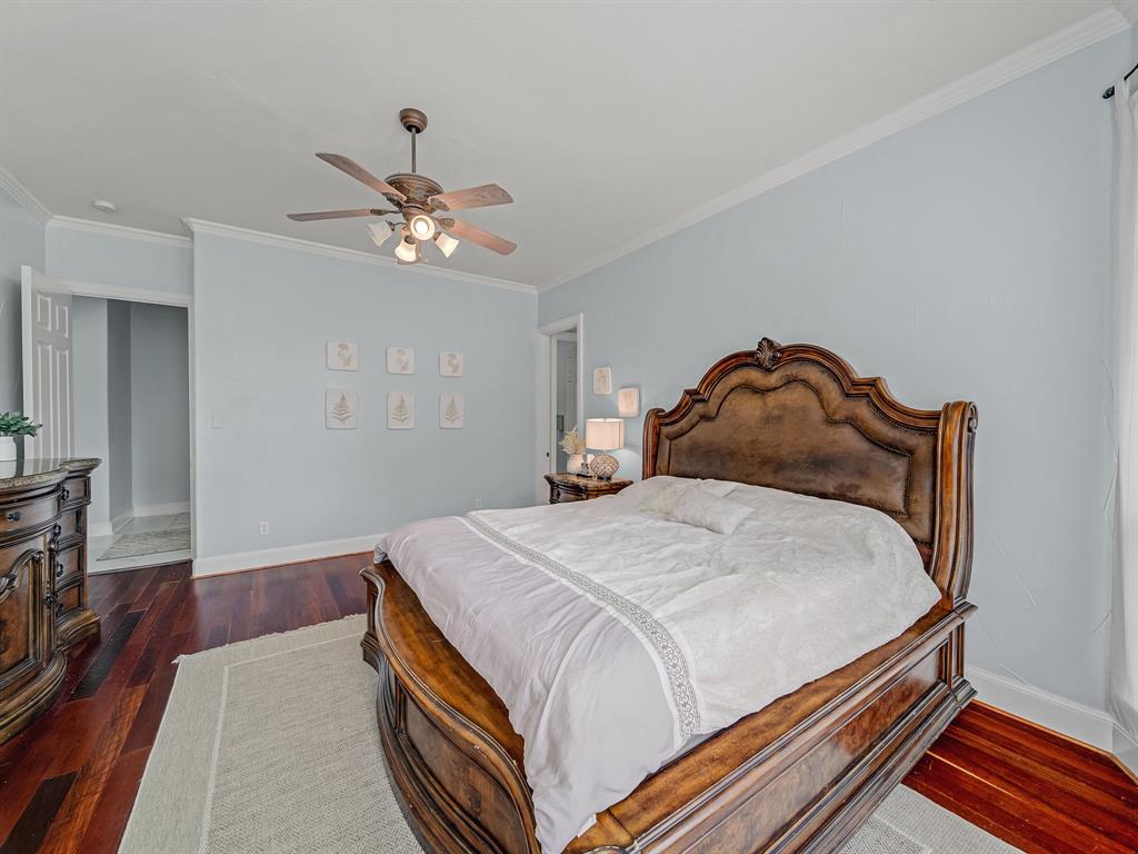 4332 Millsop Drive Carrollton, TX 75010 - Photo 28 of 37 a bedroom with a bed and wooden floor