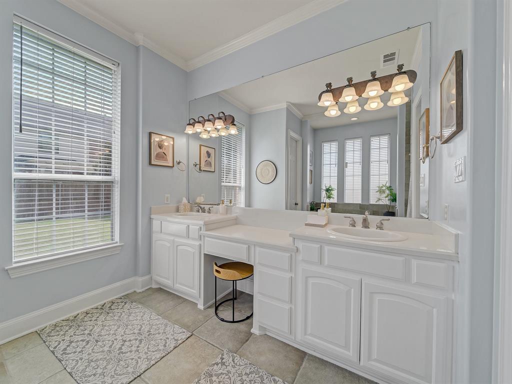 4332 Millsop Drive Carrollton, TX 75010 - Photo 29 of 37 a spacious bathroom with a sink a mirror and a shower