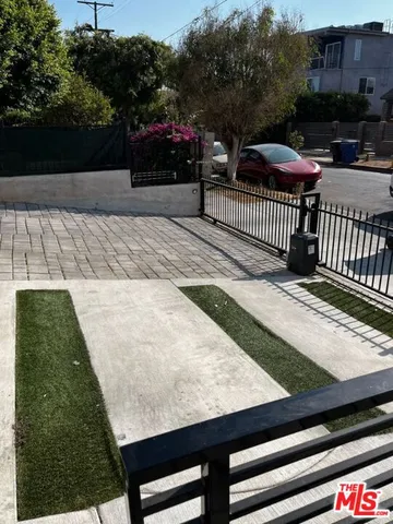 a view of a roof deck with table and chairs