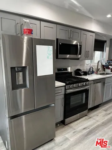 a kitchen with stainless steel appliances and wooden cabinets