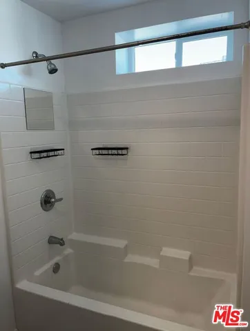 a bathroom with a bathtub and shower