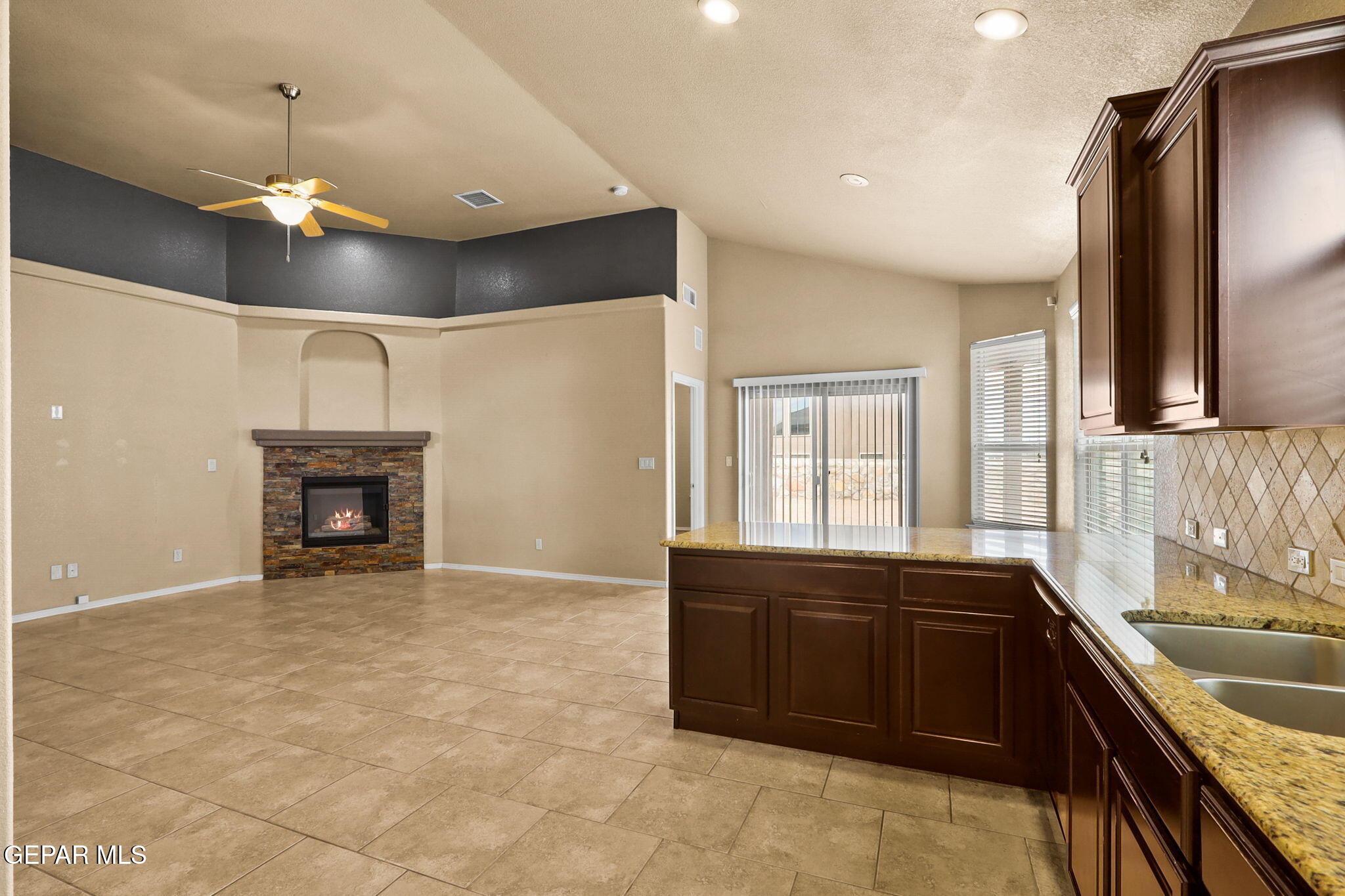 14353 Arabian Point El Paso, TX 79938 - Photo 12 of 48 a large kitchen with a sink and dishwasher a stove top oven with wooden floor