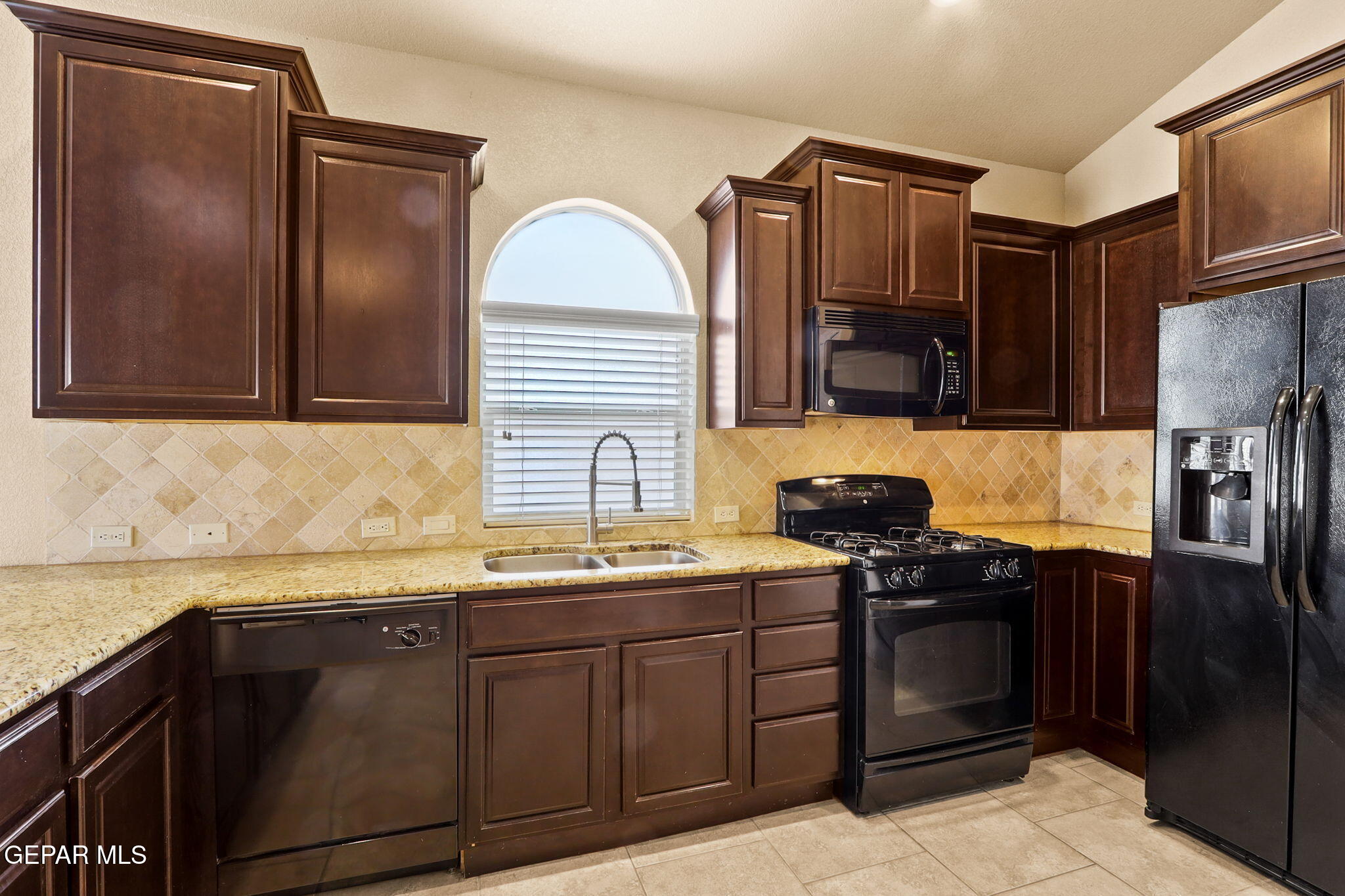 14353 Arabian Point El Paso, TX 79938 - Photo 14 of 48 a kitchen with stainless steel appliances granite countertop a sink stove and refrigerator