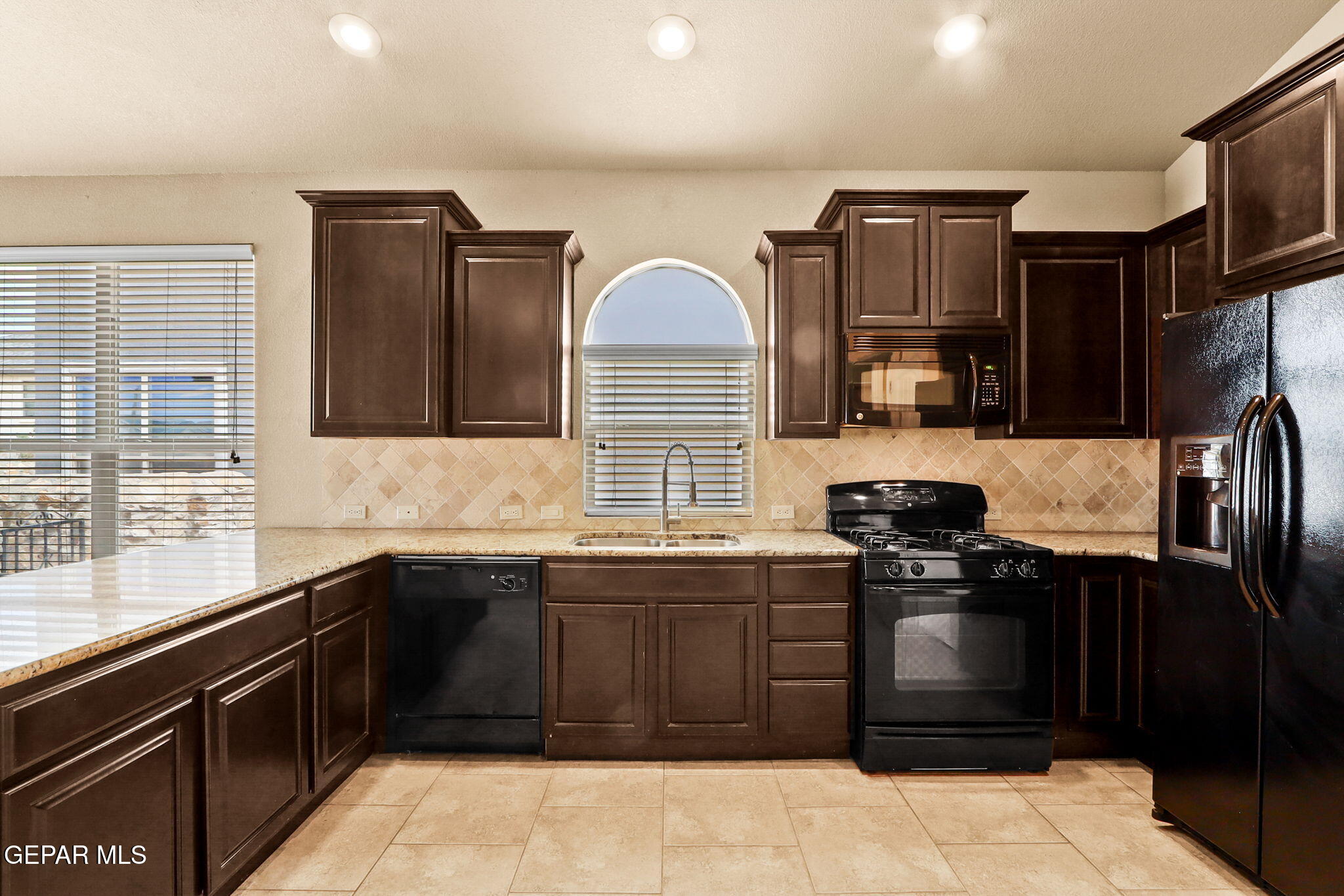 14353 Arabian Point El Paso, TX 79938 - Photo 15 of 48 a kitchen with a sink stove and refrigerator