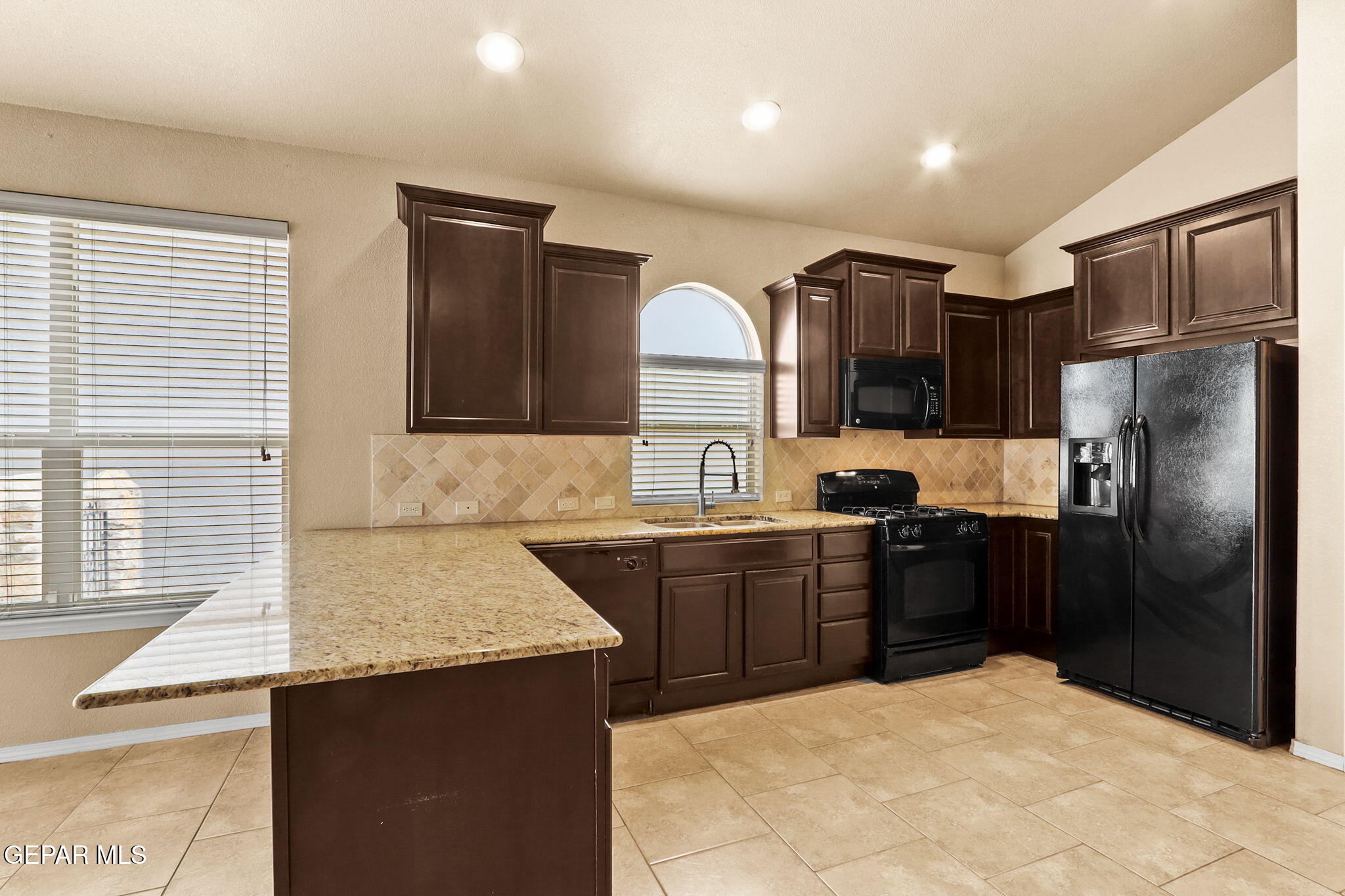 14353 Arabian Point El Paso, TX 79938 - Photo 16 of 48 a large kitchen with cabinets