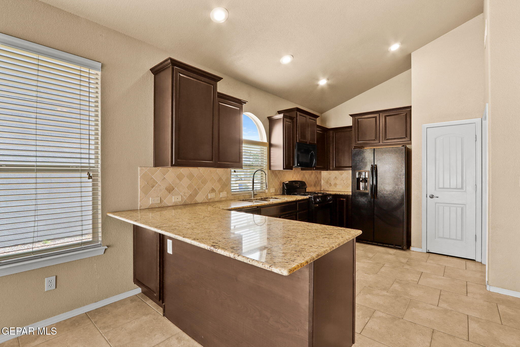 14353 Arabian Point El Paso, TX 79938 - Photo 17 of 48 a large kitchen with stainless steel appliances granite countertop a refrigerator a sink and a stove