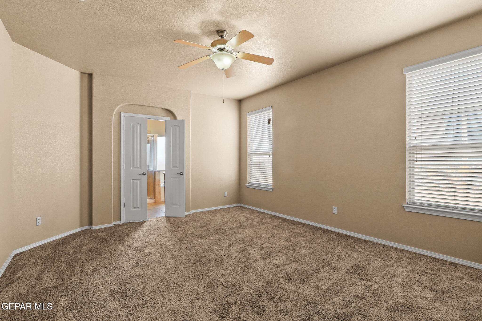 14353 Arabian Point El Paso, TX 79938 - Photo 20 of 48 an empty room with windows and fan