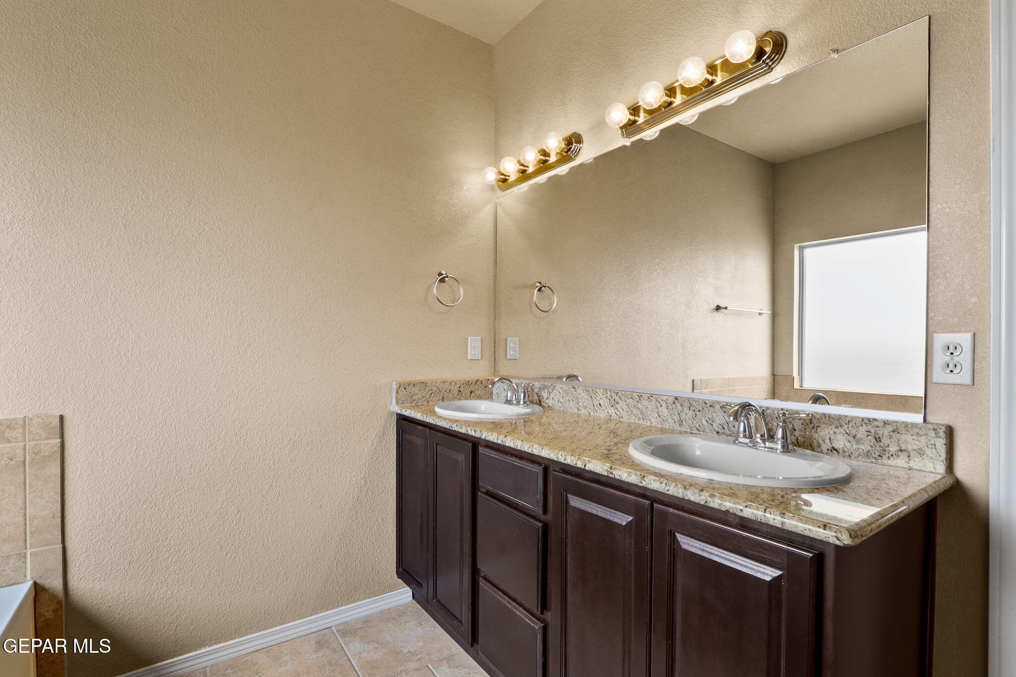 14353 Arabian Point El Paso, TX 79938 - Photo 22 of 48 a bathroom with a granite countertop sink and a mirror