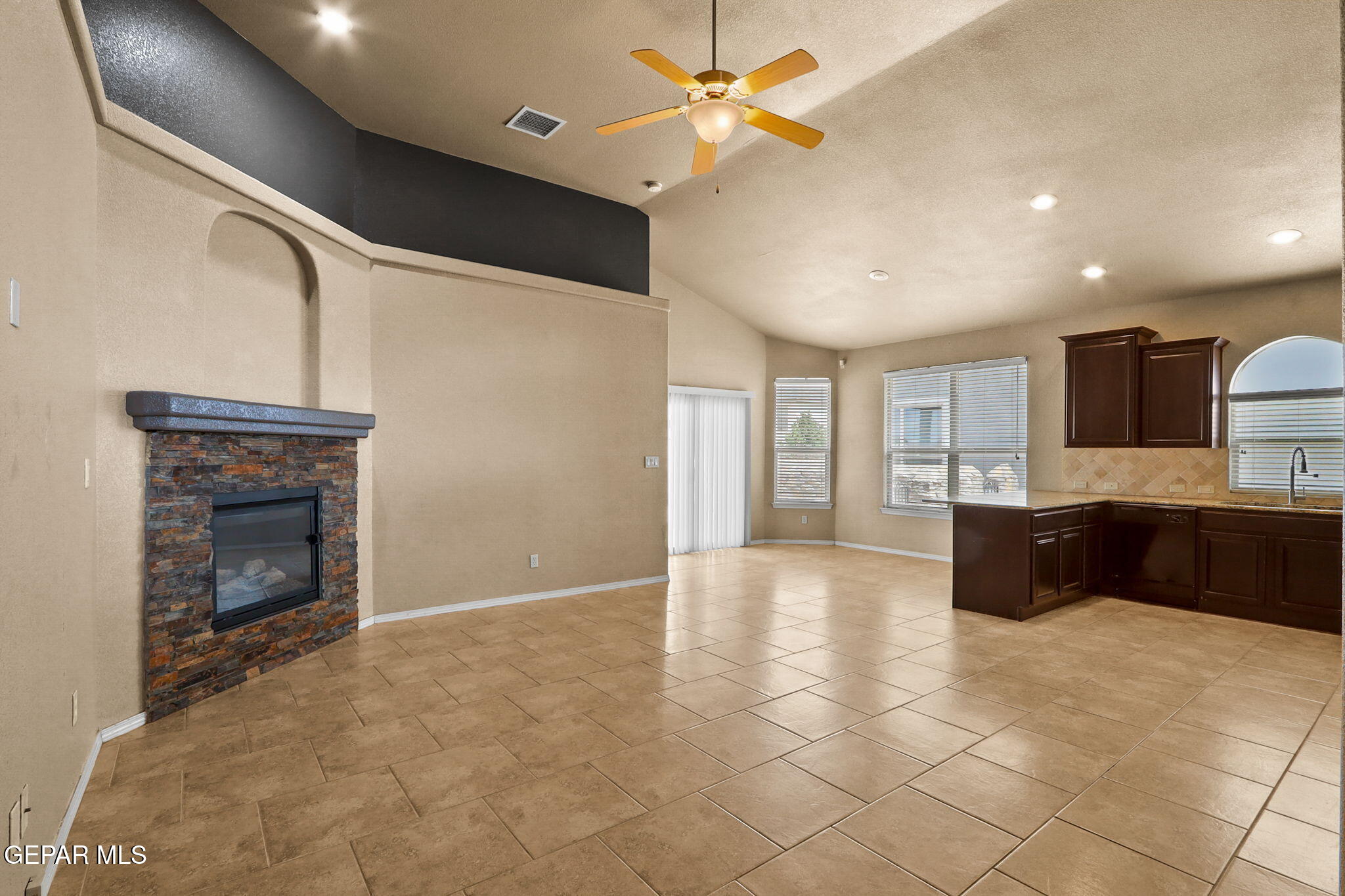 14353 Arabian Point El Paso, TX 79938 - Photo 5 of 48 a large kitchen with granite countertop a stove top oven a sink a counter space and cabinets