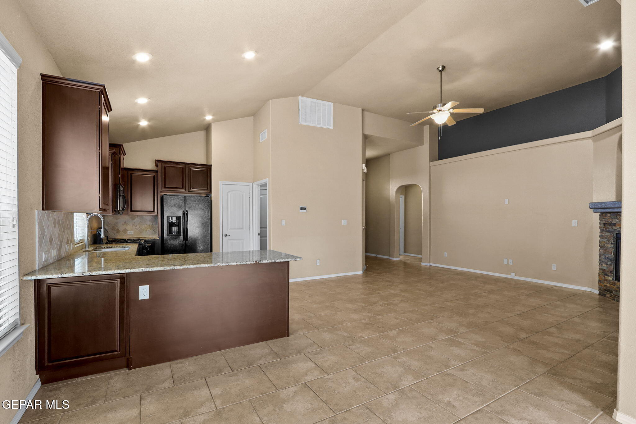 14353 Arabian Point El Paso, TX 79938 - Photo 9 of 48 a kitchen with stainless steel appliances granite countertop a refrigerator and a sink